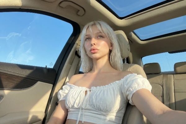 NSFW AI Image Generator: Custom Ai Girlfriend Blonde White Top Car Selfie